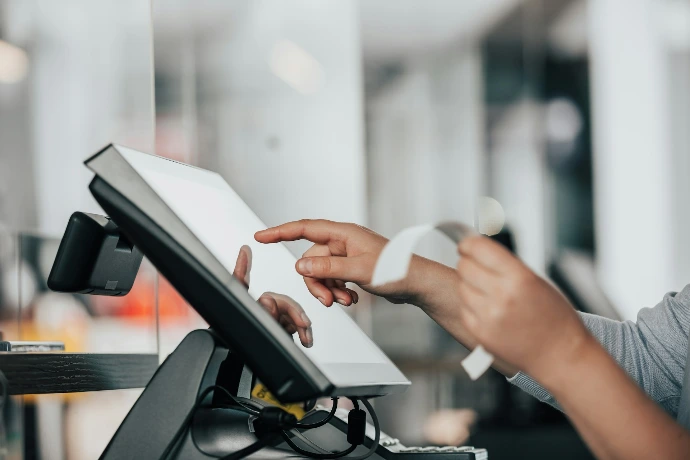 a person is using a pos machine in a store
